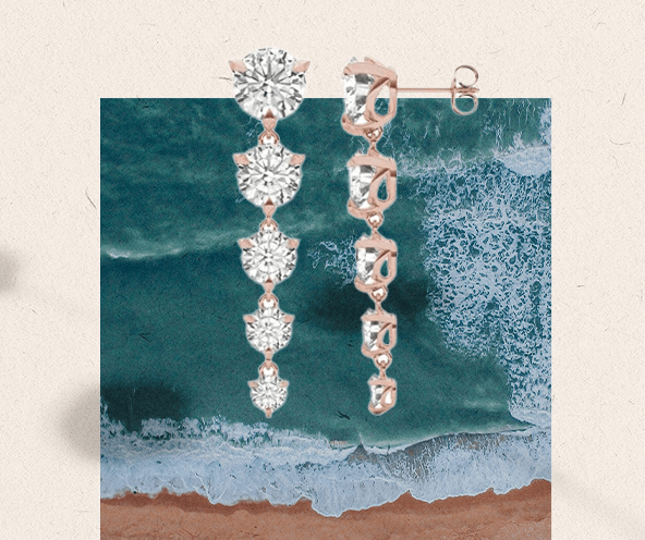 earrings with an ocean behind it