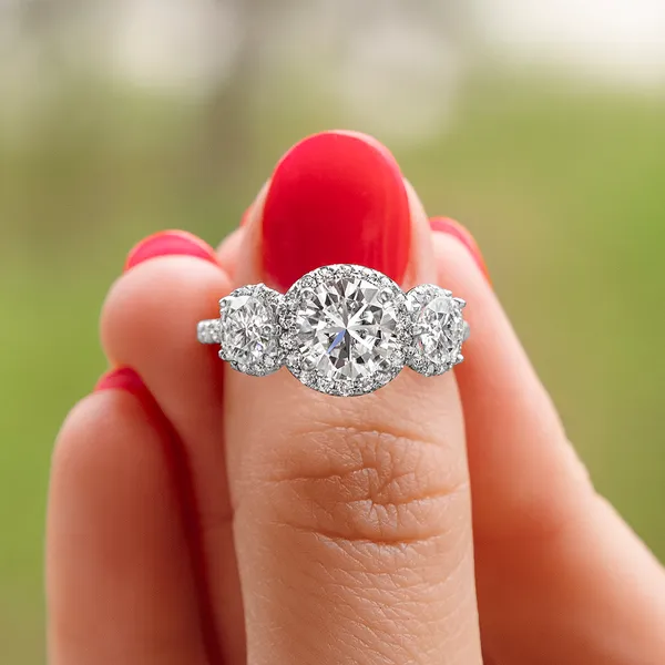 Round Brilliant Three Stone Accented Halo Engagement Ring
